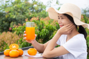 beautiful-woman-wearing-white-t-shirt-holding-glass-orange-juice
