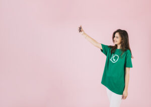 woman-taking-selfie-cellphone-wearing-whatsapp-icon-t-shirt