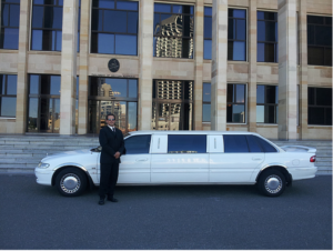 A Chauffeur Standing Beside Aesthetic White Limousine