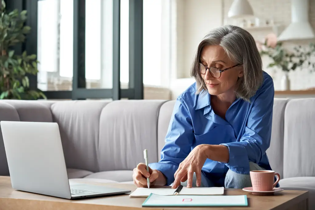 An-older-woman-reviews-her-retirement-plans-in-her-living-room